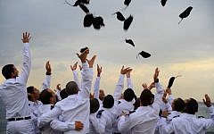 Graduating naval officers of the Israeli Navy toss their hats during a graduation ceremony (Photo credit: Ofir Shifrin/ IDF Spokesperson/Flash 90)