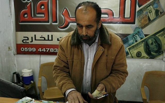 Illustrative photo of a Palestinian vendor counting shekels in Gaza. (photo credit: Abed Rahim Khatib/Flash90)