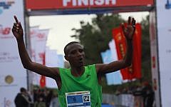 Abraham Kabeto Katale of Ethiopia crosses the finish line first at the Jerusalem marathon on Friday (photo credit: Yossi Zamir/Flash90)