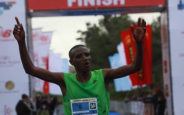 Abraham Kabeto Katale of Ethiopia crosses the finish line first at the Jerusalem marathon on Friday (photo credit: Yossi Zamir/Flash90)