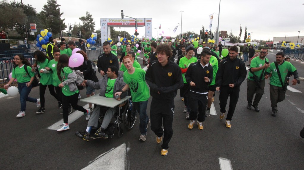 Beitar Jerusalem player Gabriel Kadiev, a Muslim from Chechnya, looks chilly as he takes part in the Jerusalem marathon on Friday (photo credit: Yossi Zamir/Flash90)