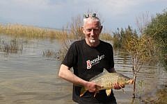 A fisherman with his catch in the Sea of Galilee, on February 18, 2013 (photo credit: Gershon Elinson/Flash90)