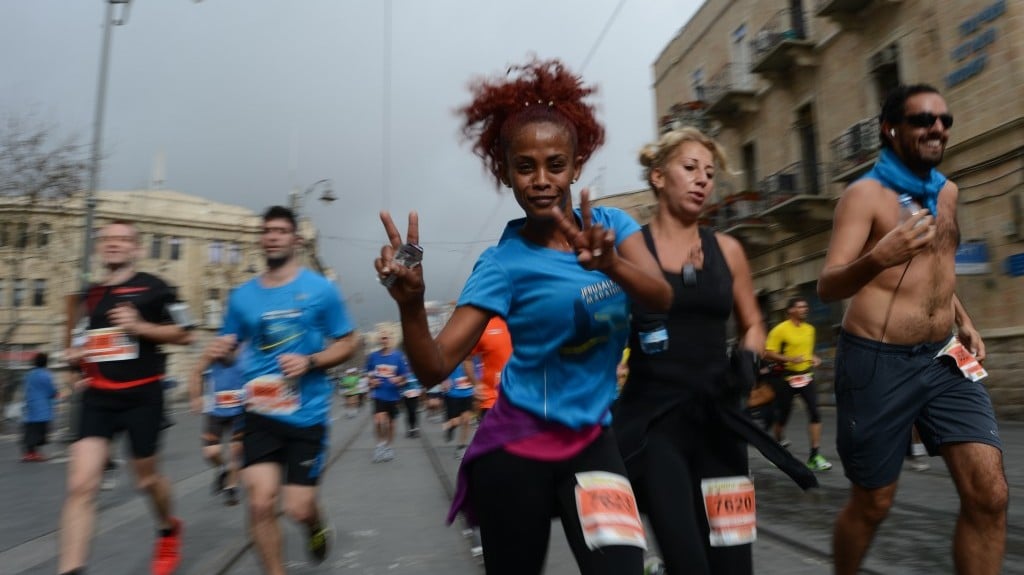 Participants smile through the pain during the Jerusalem marathon on Friday (photo credit: Flash90)