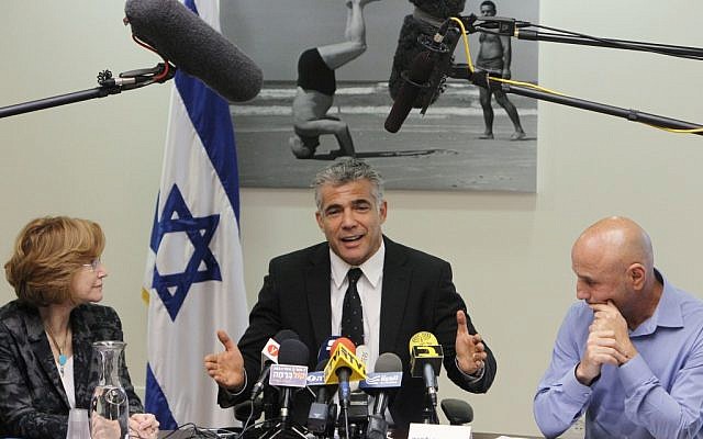 Yair Lapid, center, at a party meeting with MKs Yael German, left, and Ofer Shelach in the Knesset on Monday. (photo credit: Miriam Alster/Flash90)