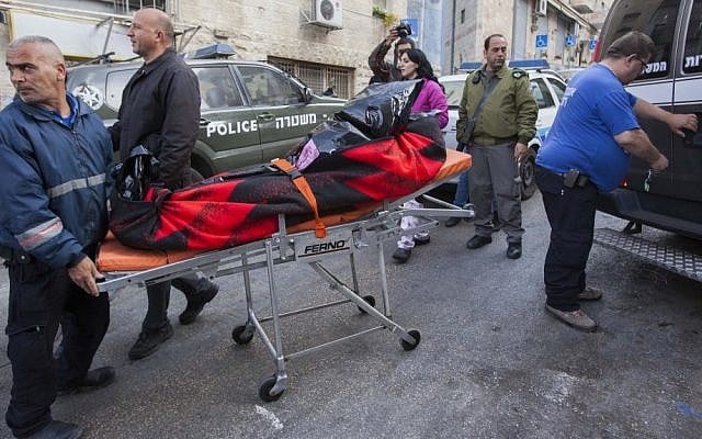Paramedics carry a body from the scene of an alleged murder in Jerusalem on Saturday. Apparently, a man in his 80s murdered his wife and attempted to commit suicide. (photo credit: Yonatan Sindel/Flash 90)