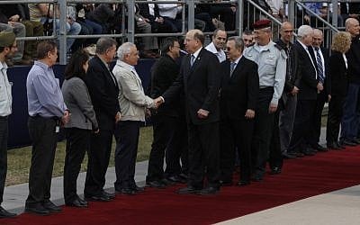 New Minister of Defense Moshe Ya'alon and his predecessor Ehud Barak shake hands with commanders at the ceremony in which Ya'alon replaced Barak. (photo credit: Flash 90). New Minister of Defense Moshe Ya'alon and his predecessor Ehud Barak shake hands with commanders at the ceremony in which Ya'alon replaced Barak. (photo credit: Flash 90).