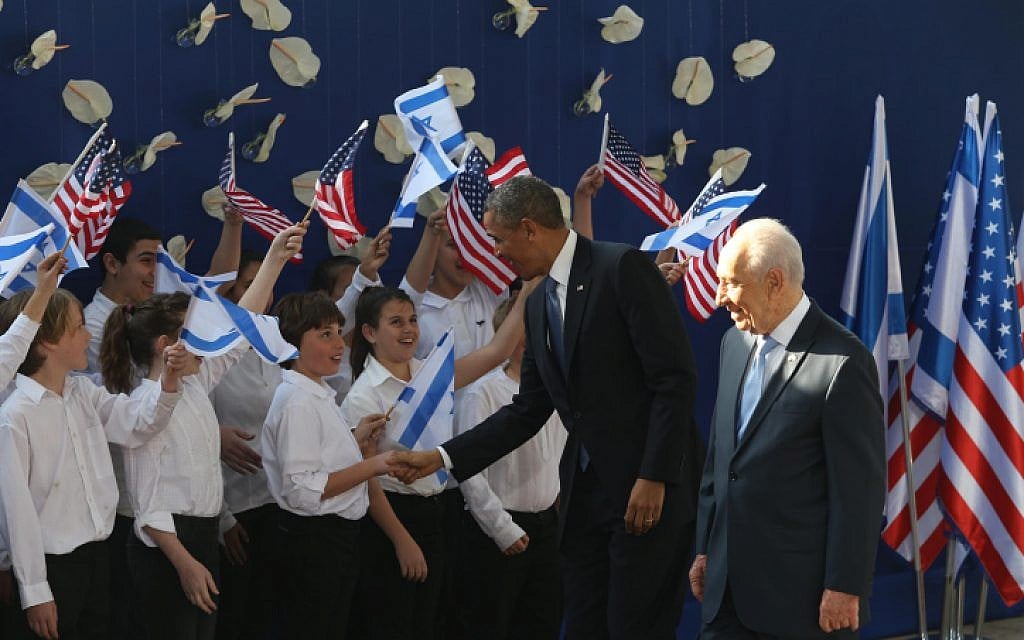 US President Barack Obama and Israeli President Shimon Peres are greeted by children outside the President's Residence in Jerusalem on March 20, 2013. (photo credit: Amit Shabi/Flash90)