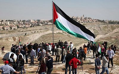 Palestinians set up the protest tent outpost in front of camera crews on March 20. (photo credit: Issam Rimawi//Flash90)