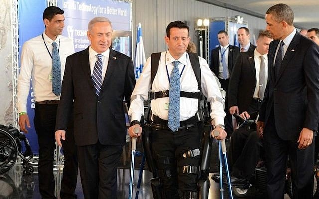 Illustrative: Prime Minister Benjamin Netanyahu (left) and former US president Barack Obama look on as disabled IDF veteran Radi Kaiuf demonstrates the ReWalk exoskeleton system. Kaiuf, who was formerly nearly fully paralyzed, completed the Israel Marathon in 2012 using the system (Kobi Gideon / GPO /FLASH90) Illustrative: Prime Minister Benjamin Netanyahu (left) and former US president Barack Obama look on as disabled IDF veteran Radi Kaiuf demonstrates the ReWalk exoskeleton system. Kaiuf, who was formerly nearly fully paralyzed, completed the Israel Marathon in 2012 using the system (Kobi Gideon / GPO /FLASH90)