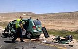 Police investigate the scene of a car accident in which two people were killed March 27 on Route 40, in the south of Israel (photo credit: Dudu Greenspan/Flash90)