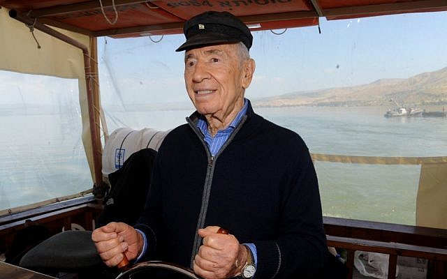 President Shimon Peres steering the boat 'The Sussita' on the Sea of Galilee on March 28, 2013. (photo credit: Gil Eliyahu/Flash 90)