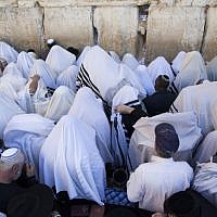 Illustrative photo of Tallit-clad worshipers at prayer in front of the Western Wall (photo credit: Yonatan Sindel/Flash90)
