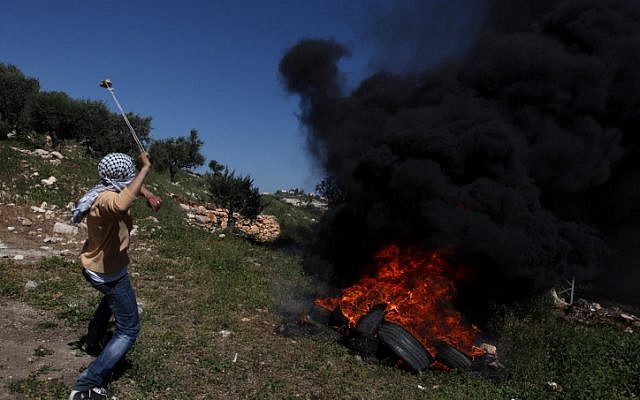 Palestinian protesters clash with Israeli soldiers near the West Bank village of Kafr Qaddum on Friday (photo credit: Issam RImawi/Flash90) Palestinian protesters clash with Israeli soldiers near the West Bank village of Kafr Qaddum on Friday (photo credit: Issam RImawi/Flash90)