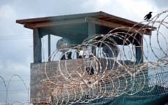 A guard stands duty in a tower over Guantanamo Bay's Detention Camp Delta, in 2007. (Army Sgt. Joseph Scozzar/Public Domain)