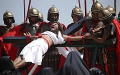 Filipino penitent Ruben Enaje, who has portrayed as Jesus Christ for 27 times, grimaces as he is nailed to the cross during Good Friday rituals on March 29, 2013 at Cutud, Pampanga province, northern Philippines (AP Photo/Aaron Favila)