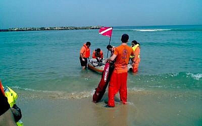 ZAKA personnel search for the body of 26-year-old Nahed Sariye in Ashkelon, Sunday. (photo credit: Boaz Ben-Ari/ZAKA)