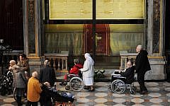 Faithful pass by the Shroud of Turin that went on display for a special TV appearance Saturday, March 30. (photo credit: AP/Alessandro Di Marcol)