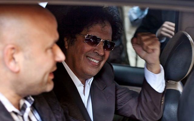 Ahmed Qaddaf al-Dam, cousin of Libya’s former dictator Moammar Gadhafi, gestures to supporters from a car after being arrested in Cairo, Egypt, on March 19. 2013. (photo credit: AP Photo/Khalil Hamra) Ahmed Qaddaf al-Dam, cousin of Libya’s former dictator Moammar Gadhafi, gestures to supporters from a car after being arrested in Cairo, Egypt, on March 19. 2013. (photo credit: AP Photo/Khalil Hamra)
