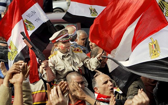Egyptian pro-military supporters carry Yousef Mohammed, 7, as he wears a representation of a military uniform during a protest in Cairo, Egypt, Friday, March 1 (photo credit: AP/Amr Nabil)