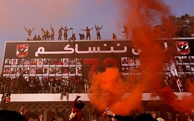 Egyptian soccer fans of Al-Ahly club celebrate in front of their club in Cairo, Egypt, Saturday, March 9. (AP Photo/Amr Nabil)