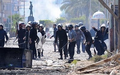 Riot police clash with protesters in Port Said, Egypt (photo credit: AP Photo)