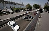 Egyptian motorists turn back with their vehicles after protesters closed the main street by the Nile river in downtown Cairo, Egypt, Sunday, March 10, 2013  (Photo credit: AP/Nasser Nasser).