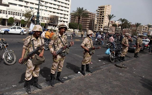 Egyptian army soldiers stand guard as they take control of the state security building after several days of clashes between protesters and riot police in Port Said, Egypt, Friday, March 8, 2013. (photo credit: AP/Khalil Hamra) Egyptian army soldiers stand guard as they take control of the state security building after several days of clashes between protesters and riot police in Port Said, Egypt, Friday, March 8, 2013. (photo credit: AP/Khalil Hamra)