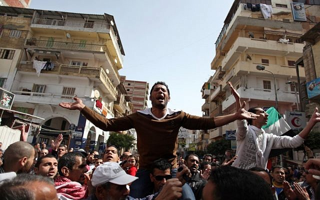 Egyptian protesters chant angry slogans during a demonstration after the noon prayer in Port Said, Egypt, Friday, March 8, 2013. With the country in chaos from weeks of protests against the Islamist president, the police have now joined the fray, launching their own protests (photo credit: AP/Khalil Hamra) Egyptian protesters chant angry slogans during a demonstration after the noon prayer in Port Said, Egypt, Friday, March 8, 2013. With the country in chaos from weeks of protests against the Islamist president, the police have now joined the fray, launching their own protests (photo credit: AP/Khalil Hamra)