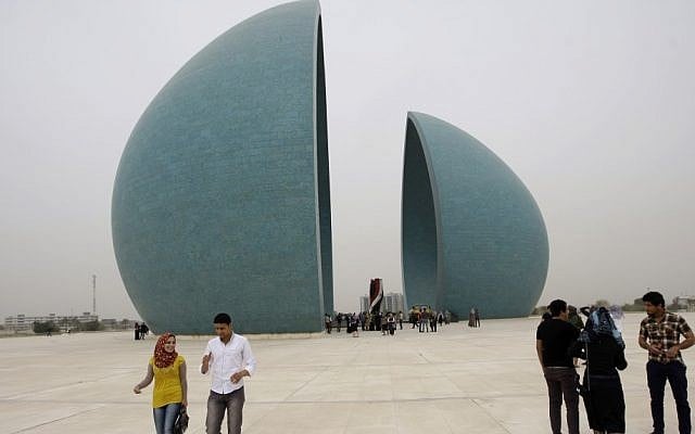 Iraqis visit the Shaheed Monument in Baghdad, March 5, 2013. Saddam Hussein had the split teardrop-shaped sculpture built in the middle of a man-made lake in the early 1980s to commemorate Iraqis killed in the Iran-Iraq War. (photo credit: AP/Khalid Mohammed)