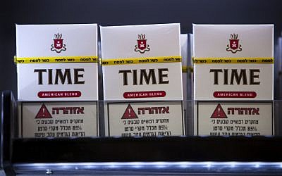 Cigarettes for sale with a stamp of approval reading in Hebrew 'Kosher for Passover' at a kiosk in the ultra-Orthodox town of Bnei Brak, near Tel Aviv, Monday, March. 25, 2013. (Photo credit: AP Photo/Oded Balilty)