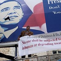 Palestinian activists throw shoes at a poster of US President Barack Obama in the West Bank city of Bethlehem, Monday, March 18, 2013. (photo credit: AP/Nasser Shiyoukhi)