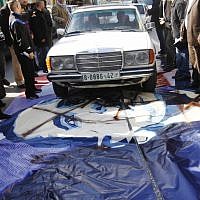 A man drives his car over a poster of US President Barack Obama in the West Bank city of Bethlehem, Monday, March 18, 2013. (photo credit: AP/Nasser Shiyoukhi)