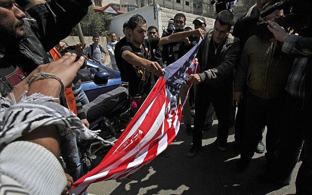 Palestinians rip an American flag during a protest against the visit of the U.S. President Barack Obama in Gaza City, Wednesday, March 20, 2013 (photo credit: AP/Adel Hana) Palestinians rip an American flag during a protest against the visit of the U.S. President Barack Obama in Gaza City, Wednesday, March 20, 2013 (photo credit: AP/Adel Hana)