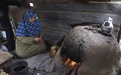 In this Monday, March 18, 2013 photograph, Palestinian Nabila Qishta, 52, prepares bread in the southern Gaza Strip town of Rafah, using flour donated by the UN (photocredit: AP/Diaa Hadid)