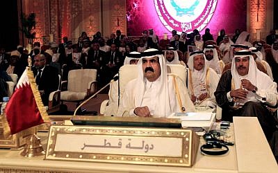 Emir of Qatar Sheik Hamad Bin Khalifa Al Thani, center, attends the opening session of the Arab League Summit in Doha, Qatar, Tuesday. (AP Photo/Ghiath Mohamad)