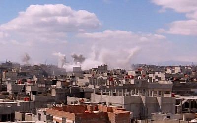 Columns of smoke rise from heavy bombing by Syrian government forces in Arbeen, Syria, on Monday March 18, 2013. (photo credit: AP/Shaam News Network via AP video)