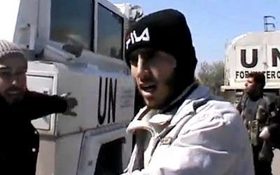 Free Syrian Army fighters stand next to United Nations Disengagement Observer vehicles near Golan Heights in the southern province of Daraa, Syria on Wednesday. (photo credit: AP/Ugarit News via AP video) Free Syrian Army fighters stand next to United Nations Disengagement Observer vehicles near Golan Heights in the southern province of Daraa, Syria on Wednesday. (photo credit: AP/Ugarit News via AP video)