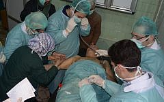 A Syrian man who suffered an alleged chemical attack receives treatment at a hospital in Aleppo, Syria, in March. (photo credit: AP/SANA)