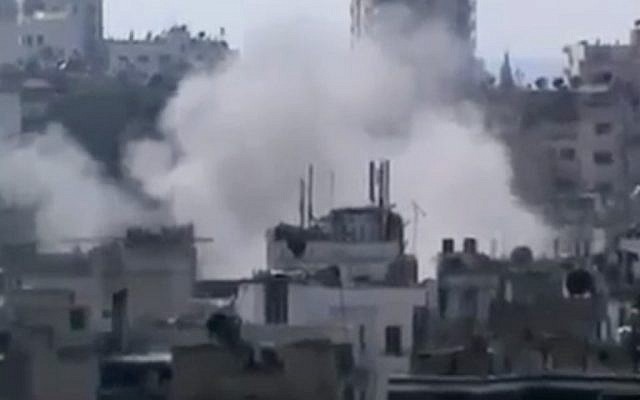 Smoke rises from buildings due heavy shelling in Homs, Syria, on Monday, March 11, 2013. (photo credit: AP Photo/Shaam News Network via AP video) Smoke rises from buildings due heavy shelling in Homs, Syria, on Monday, March 11, 2013. (photo credit: AP Photo/Shaam News Network via AP video)