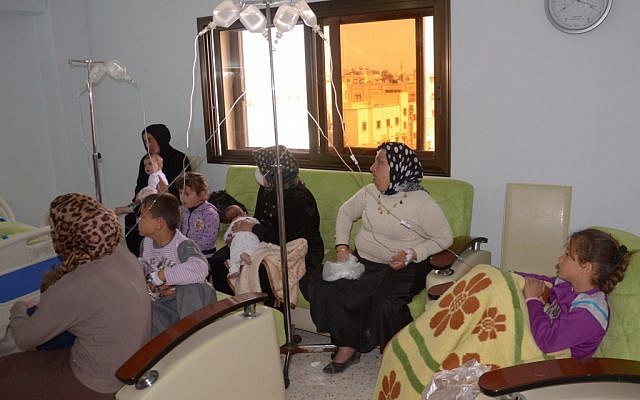 In this photo released by the Syrian official news agency SANA, Syrian victims who suffered an alleged chemical attack at Khan al-Assal village according to SANA, receive serum treatments, at a hospital in Aleppo, Syria, Tuesday March 19, 2013 (photo credit: AP/SANA) In this photo released by the Syrian official news agency SANA, Syrian victims who suffered an alleged chemical attack at Khan al-Assal village according to SANA, receive serum treatments, at a hospital in Aleppo, Syria, Tuesday March 19, 2013 (photo credit: AP/SANA)