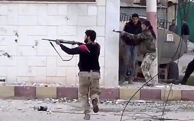 Free Syrian Army fighters fire at government soldiers during a fierce firefight in Daraa al-Balad, Syria, on Monday March 18, 2013. (AP Photo/Shaam News Network via AP video)