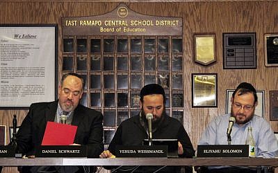 East Ramapo School Board President Daniel Schwartz and board members Yehuda Weissmandl and Eliyahu Solomon attend a board meeting on Tuesday, March 19, 2013, in Spring Valley, New York. (photo credit: AP/Jim Fitzgerald)