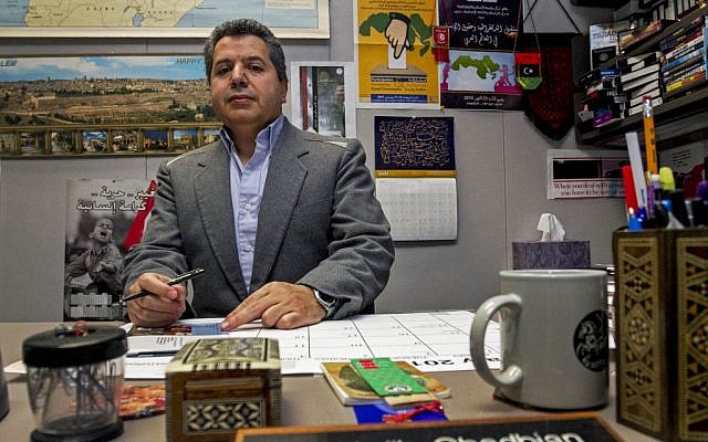 Dr. Najib Ghadbian sits in his office at the University of Arkansas. Ghadbian was recently named a Syrian opposition representative for the United States. (photo credit: AP/Gareth Patterson)