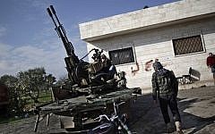 A Syrian rebel checks an anti-aircraft weapon in Maaret Misreen, near Idlib, Syria, on Friday, Dec. 14, 2012 (photo credit: AP/Muhammed Muheisen/File)