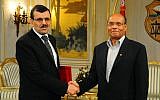 Tunisian Prime Minister Ali Larayedh, right, shakes hands with Tunisian President Moncef Marzouki, left, in Tunis on Friday, March 8 (photo credit: AP/Hassene Dridi)