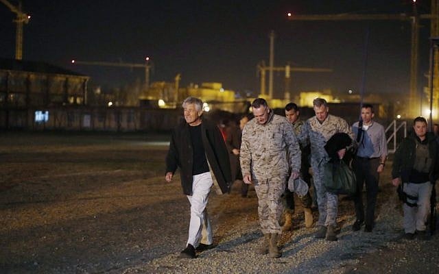 Defense Secretary Chuck Hagel walks with US Marine General Joseph Dunford, Commander of the International Security Force upon Hagel's arrival near Camp Eggers in Kabul, Afghanistan, Friday. Hagel arrived in Afghanistan Friday for his first visit as Pentagon chief, saying that there are plenty of challenges ahead as NATO hands over the country's security to the Afghans. (AP Photo/Jason Reed, Pool)