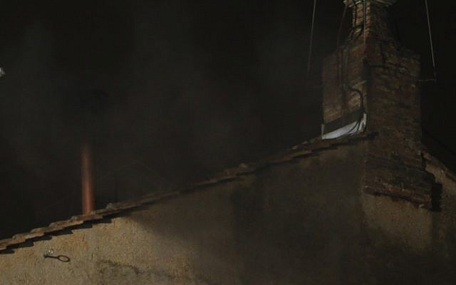 Black smoke emerges from the chimney on the roof of the Sistine Chapel, in St. Peter's Square at the Vatican, Tuesday, March 12, 2013. (photo credit: AP Photo/Dmitry Lovetsky) Black smoke emerges from the chimney on the roof of the Sistine Chapel, in St. Peter's Square at the Vatican, Tuesday, March 12, 2013. (photo credit: AP Photo/Dmitry Lovetsky)