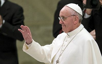 Pope Francis waves as he arrives for a meeting with the media at the Paul VI hall, at the Vatican Saturday, March 16, 2013. Pope Francis met thousands of journalists and media workers coming from 81 countries at Paolo VI hall on Saturday. (AP Photo/Alessandra Tarantino)