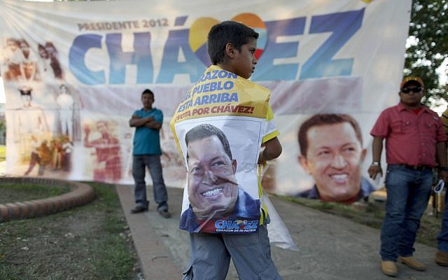 A boy stands in front of a banner of late President Hugo Chavez at the main square of his hometown, Sabaneta, in western Venezuela, Friday. (photo credit: AP/Esteban Felix) A boy stands in front of a banner of late President Hugo Chavez at the main square of his hometown, Sabaneta, in western Venezuela, Friday. (photo credit: AP/Esteban Felix)