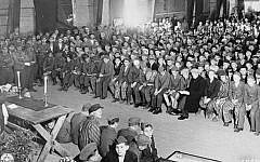 Rabbi Herschel Schachter conducts services for Holocaust survivors on the Jewish festival of Shavuot, in the Buchenwald concentration camp, May 16, 1945. (Wikimedia Commons)